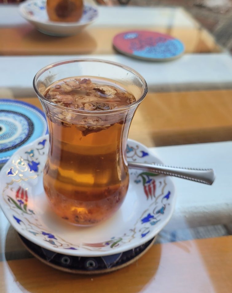 Glass of Turkish tea served on a decorative saucer at an Istanbul café